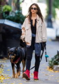 Emily Ratajkowski rocks bright red sneakers with a denim jacket and leggings while walking her dog in New York City