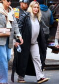 Hilary Duff stays cozy in her sweats and a black leather trench coat while out on a stroll with friends in Tribeca, New York City