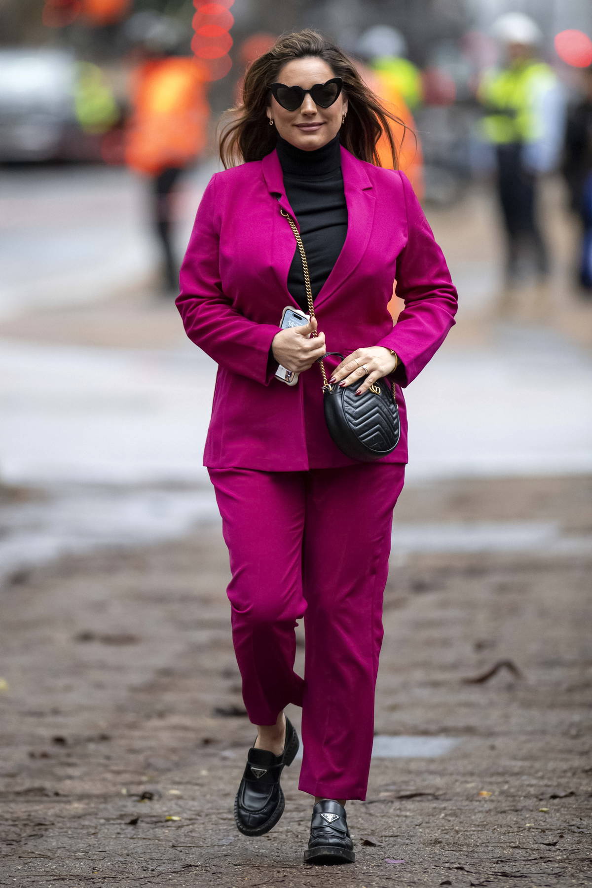 Kelly Brook seen wearing a magenta suit while filming a SlimFast advert with Big Narstie in Central London, UK