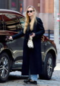 Sophie Turner wore a black trench coat, jeans and black loafers while out in New York City