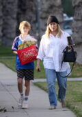 Hilary Duff wears an oversized white shirt and jeans while out with her kids in Beverly Hills, California