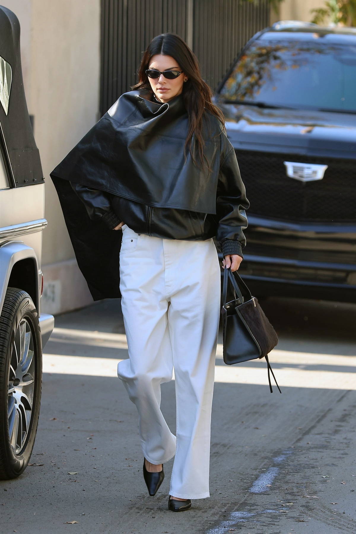 Shanina Shaik rocks black leather pants with a white tank top and