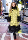 Rita Ora looks striking in a feather-trimmed yellow coat while stepping out in New York City