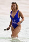 Tallia Storm slips into a blue swimsuit as she enjoys the beach during her winter break in Bridgetown, Barbados