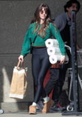 Alison Brie sports a cropped in a green sweatshirt and black leggings while shopping groceries in Los Angeles