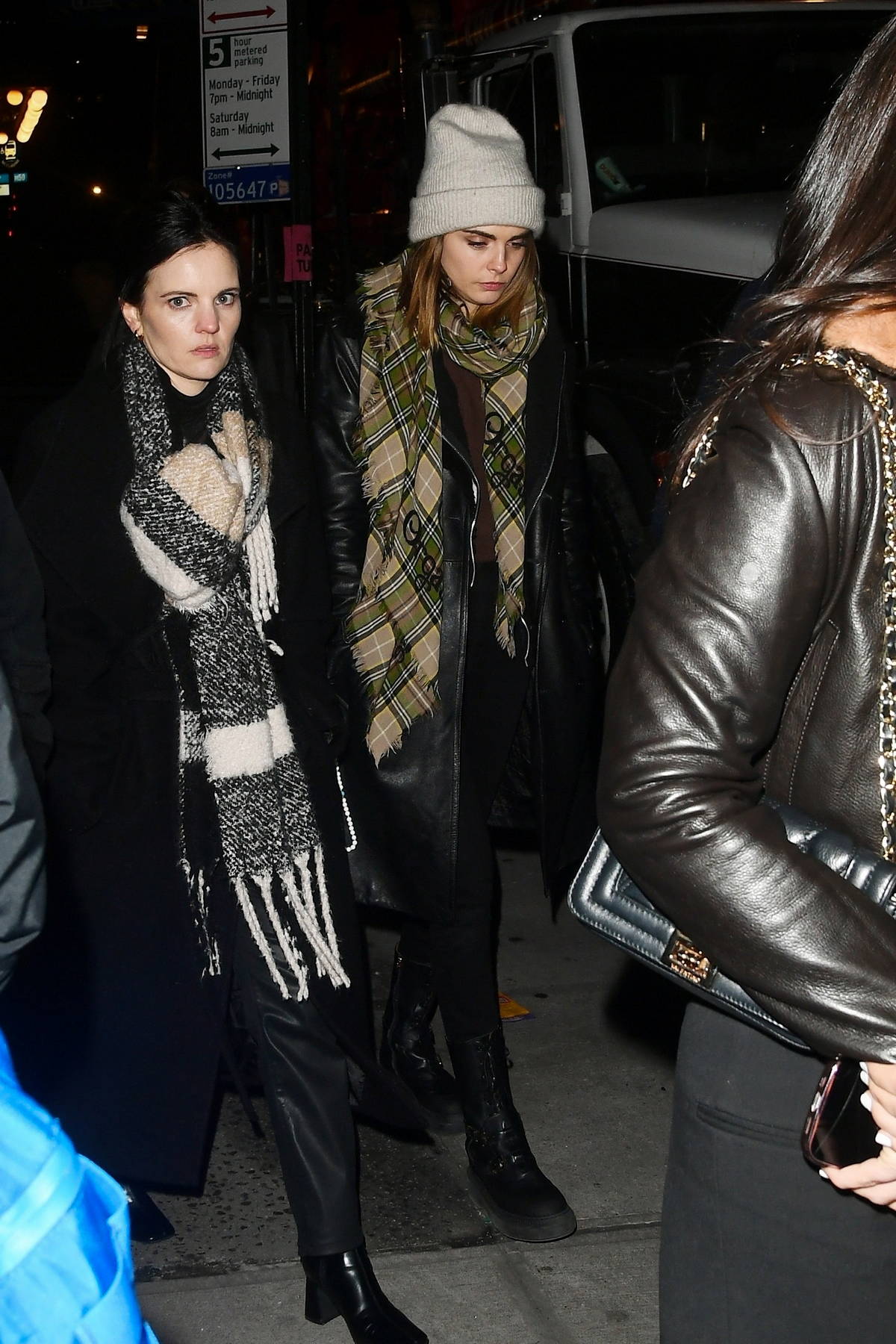 Cara Delevingne bundles up in winter clothes as she arrives at the