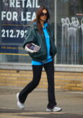 Emily Ratajkowski rocks a blue hoodie and black flared leggings while out on a morning stroll in New York City