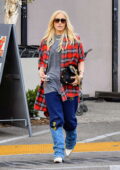 Gwen Stefani dons an oversized flannel shirt, a t-shirt and sweatpants with denim boots while shopping groceries in Los Angeles