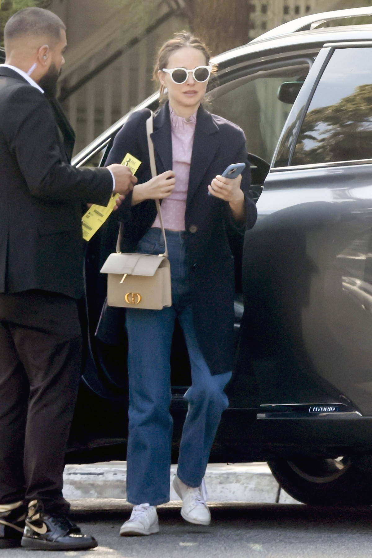 Natalie Portman dons a black long coat with pink top and jeans while stepping out for lunch in West Hollywood, California