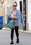 Olivia Wilde is all smiles as she leaves the gym sporting a pink sweatshirt, purple leggings and denim jacket in Studio City, California