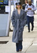 Addison Rae looks chic in a grey overcoat paired with a pearl necklace, jeans and a hat while out for a stroll in New York City