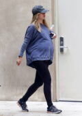 Suki Waterhouse shows her growing baby bump in a blue sweatshirt and black leggings while heading for a morning workout in Los Angeles