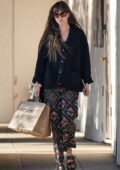 Dakota Johnson looks radiant in a black cardigan with floral print pants while out shopping in Malibu, California