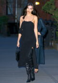 Emily Ratajkowski looks fabulous in a black evening dress with knee-high boots while stepping out for dinner in New York City