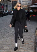 Gigi Hadid looks chic in a black blazer paired with a matching top and leggings while seen leaving her apartment in New York City