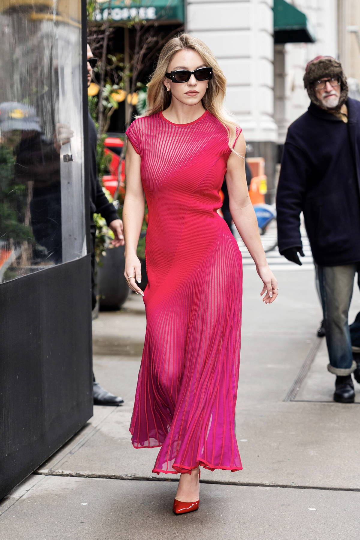 Sydney Sweeney looks striking in a hot pink dress while attending a Bai event in New York City