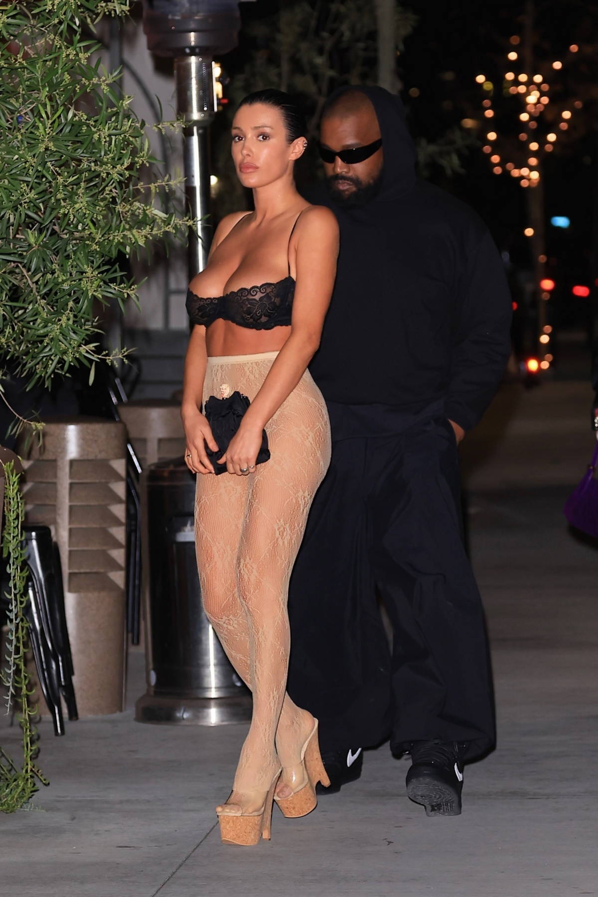 Bianca Censori stuns in a black bra top and sheer leggings during a dinner outing with Kanye West at Gigi's in Los Angeles