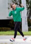 Jennifer Garner chats on her phones while enjoying her morning walk wearing a green sweatshirt and black leggings in Los Angeles