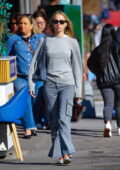 Lila Moss dons a grey sweater and striped denim while out in New York City