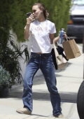 Lily-Rose Depp wears a casual white tee and jeans while stopping by a friend's house in Malibu, California