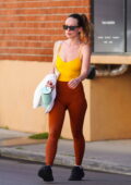 Olivia Wilde sports a bright yellow top and burnt-orange leggings while spotted leaving her daily workout in Studio City, California