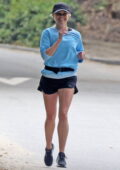 Reese Witherspoon is all smiles while out for a jog wearing a blue sweatshirt and shorts in Brentwood, California