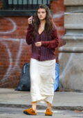 Suri Cruise looks radiant in a white skirt with a burgundy cardigan while stepping out in New York City