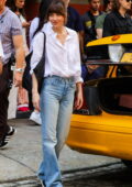 Dakota Johnson seen wearing a white shirt and blue jeans while filming with Pedro Pascal for 'Materialists' in New York City