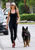 Gisele Bundchen shows off her svelte figure in a black tank top and leggings while out for walk with her dog in Miami, Florida