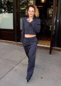 Rita Ora rocks a midriff baring suit and visor style glasses while heading out of her hotel in New York City