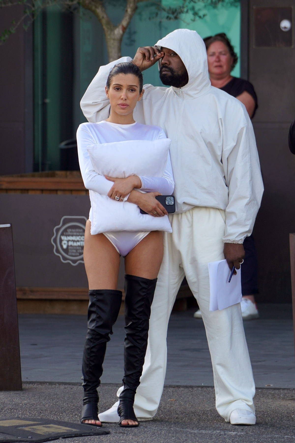 Bianca Censori puts on a cheeky display in a white bodysuit as she touches down at Florence airport with Kanye West in Italy