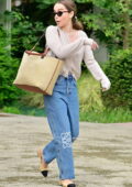 Emilia Clarke wears beige cardigan and blue jeans while stepping out in Venice, Italy