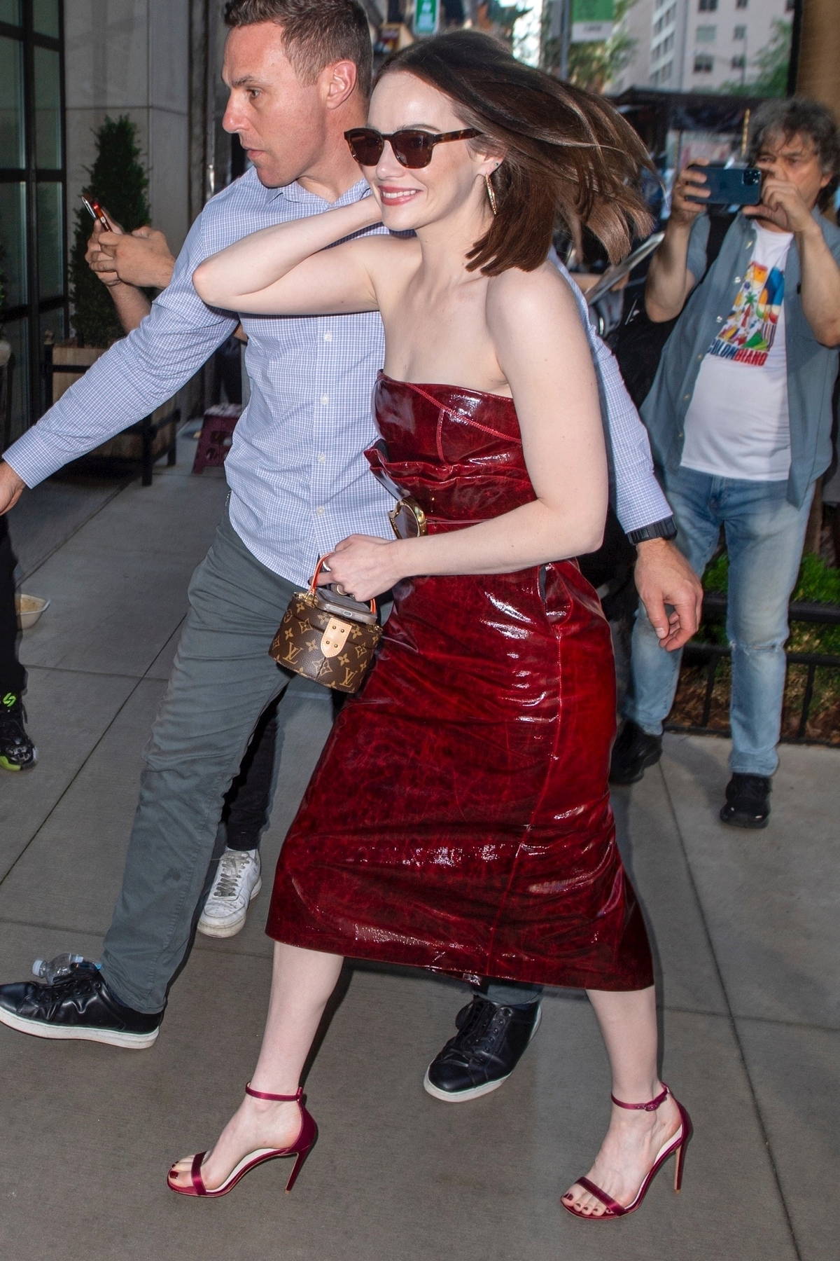 Emma Stone rocks a cherry red leather dress while attending a screening of 'Kinds of Kindness' in New York City