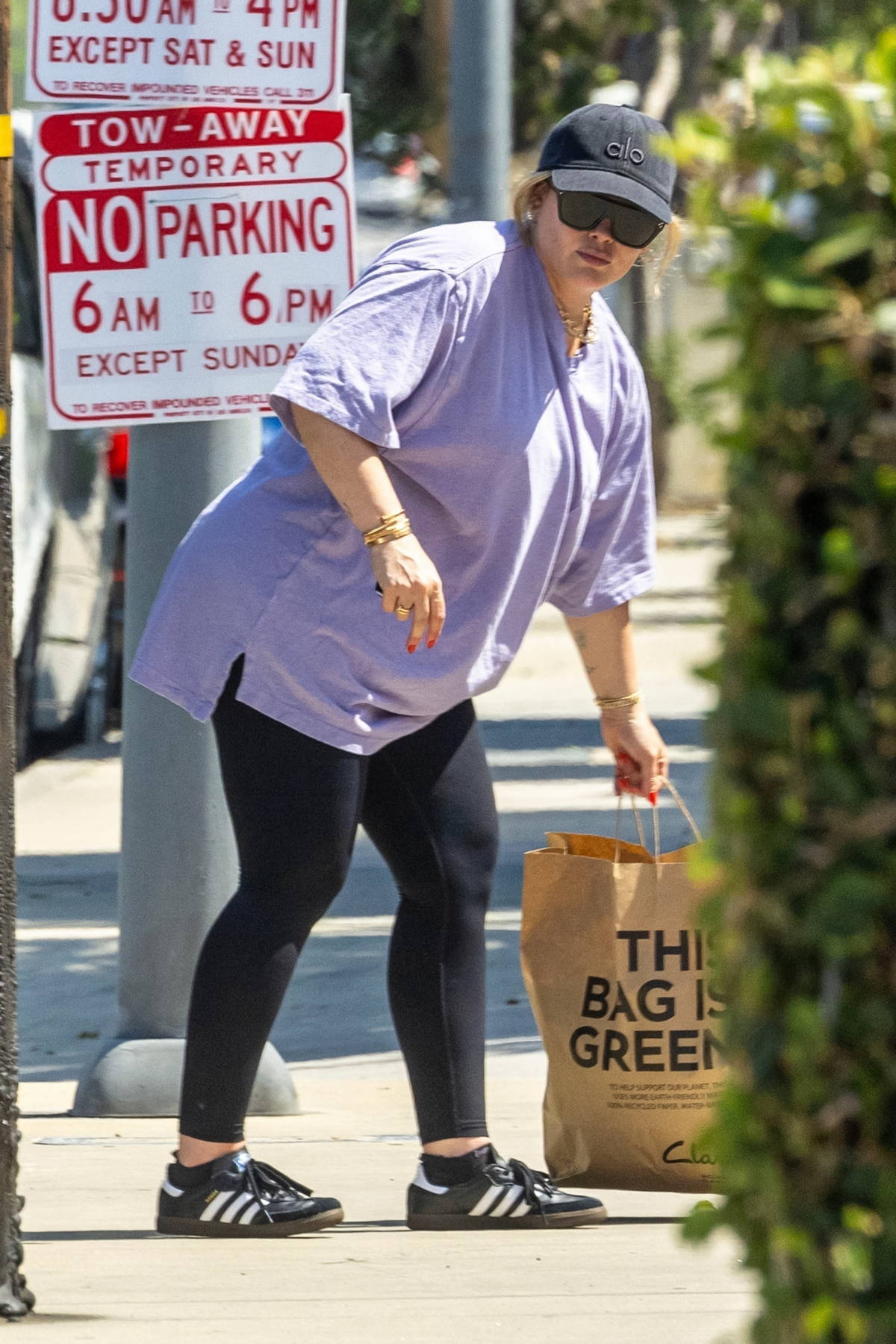 Hilary Duff dons an oversized t-shirt and leggings while running errands with her newborn baby in Los Angeles