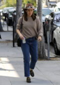 Jennifer Garner steps out wearing a hat with a grey sweater and blue jeans in Los Angeles