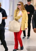 Jennifer Lawrence stands out in bright red pants and a yellow shirt while spotted at JFK airport in New York City