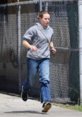 Kristen Bell wears a grey hoodie and jeans while out running errands in Los Feliz, California