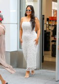 Ashley Graham flashes a big smile in a white strapless dress while visiting an Ulta Beauty Store in Manhattan, New York City