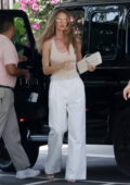 Rosie Huntington-Whiteley looks chic in an ivory bodysuit and white trousers while stopping for lunch in Beverly Hills, California