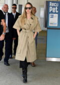 Angelina Jolie looks chic in a khaki trench coat and leather boots as she touches down at Venice airport, Italy