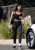 Camila Mendes sports a black crop top and leggings while seen leaving her trainer's house after a workout in Los Angeles