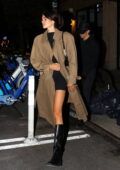 Kaia Gerber looks chic in a camel trench coat over a black mini dress while seen leaving Ella Funt with boyfriend Austin Butler in New York City