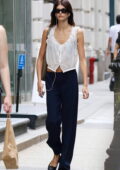 Kaia Gerber shows off her slender frame in a white top and navy pants during a solo stroll in Soho, New York City