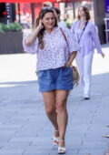 Kelly Brook looks dons a floral blouse and blue shorts as she makes a leggy appearance at Heart radio in London, England