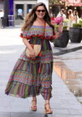 Kelly Brook looks radiant in a colorful flowing dress as she leaves after her Heart Radio show in London, England