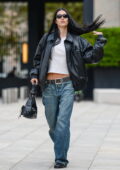 Amelia Hamlin looks trendy in a black leather jacket with a white top and baggy jeans while stepping out in Milan, Italy