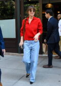 Dakota Johnson looks striking in a red shirt and blue jeans leaving The Greenwich Hotel in New York City