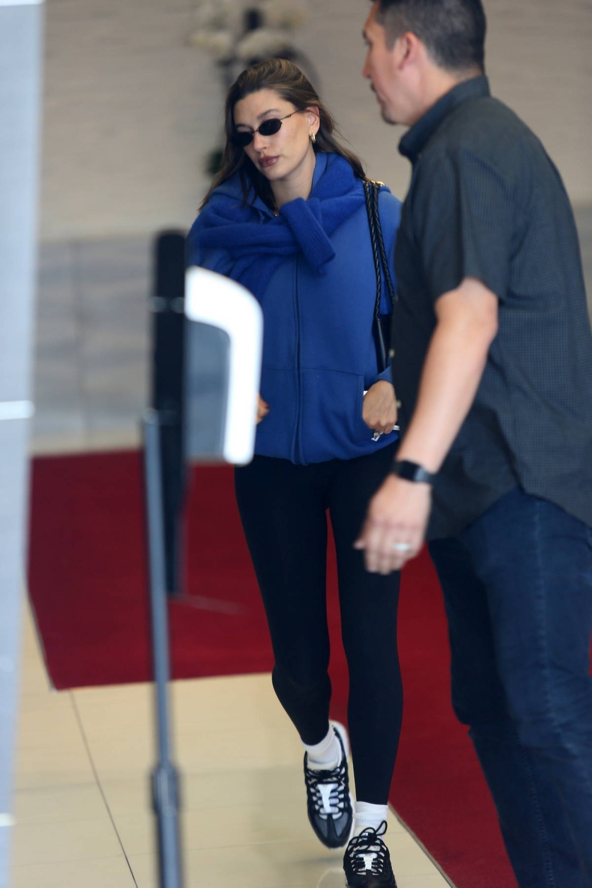 Hailey Bieber sports a blue hoodie and black leggings as she heads for a spa day in Beverly Hills, California