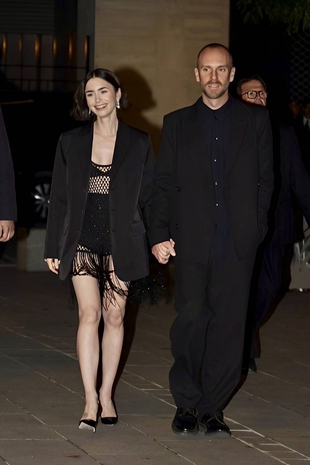 Lily Collins and Charlie McDowell hold hands as they step out for dinner in Paris, France