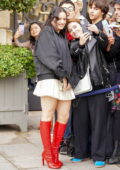 Rosalia rocks a cream mini dress with bomber jacket and red knee-high boots while seen greeting fans during PFW in Paris, France